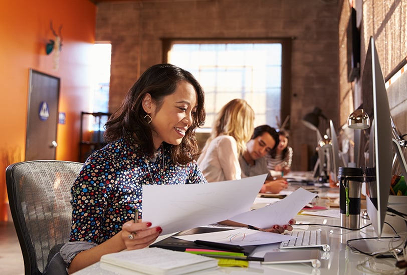 woman with paperwork at desk